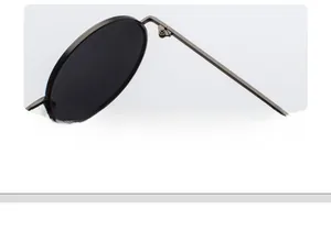 Macro detail showing the high-precision metal hinge of retro round frame sunglasses