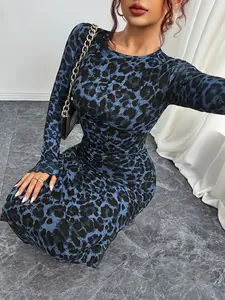 Close-up showing the intricate blue leopard print on a mesh long sleeve maxi dress.