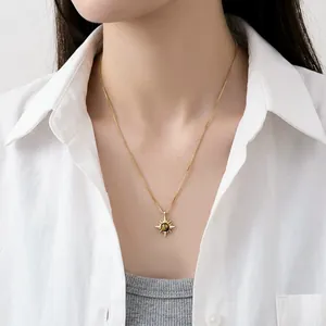 Golden sunburst necklace with tiger eye stone worn on an Asian model