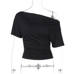 Detail view of a black asymmetrical off-shoulder slim fit T-shirt displayed on a mannequin
