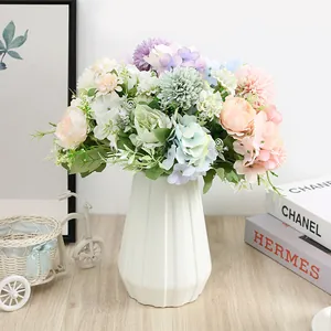 Pastel artificial flower bouquet with peonies in a white ceramic vase for home decor