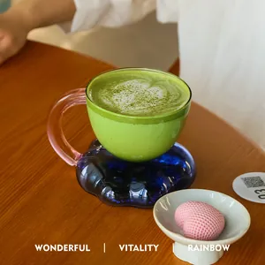 Elegant floating cloud glass mug with blue base and pink handle for coffee and latte