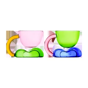 Set of two colorful floating cloud glass mugs for coffee and juice with unique bases