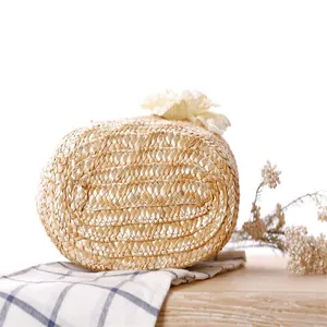 Detail shot showing the hand-woven texture on the bottom of this straw beach bag