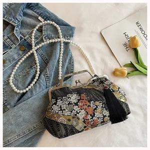 Close-up of New Chinese style embroidered bag with pearl chain and tassel