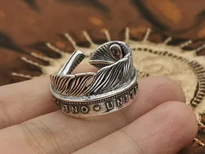 Macro detail of S925 sterling silver feather ring featuring vintage coin pattern engravings
