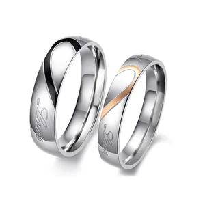 Minimalist heart split couple rings set in stainless steel with 'Love' script engraving