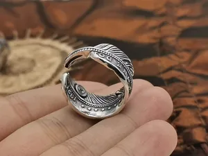 Detailed view of vintage S925 sterling silver open feather ring with 1924 engraving.