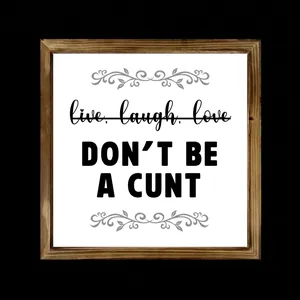 Detail view of square wooden framed sign with humorous bold black typography on white background