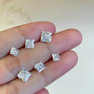 Elegant square cubic zirconia stud earrings in sterling silver on hand for scale.