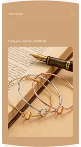 Close-up of three heart-shaped open bangles in gold, silver, and rose gold finishes