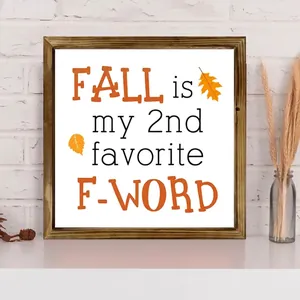 Close-up view of a square wooden frame with an autumn-themed quote and leaf art decoration.