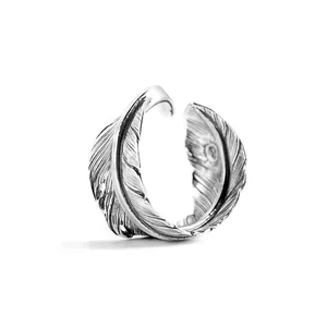 Detailed macro shot of vintage S925 silver open feather ring with antique finish