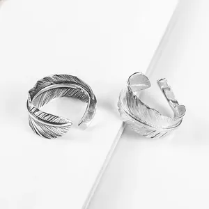 Macro view of S925 sterling silver open feather rings with intricate vintage Thai silver texture
