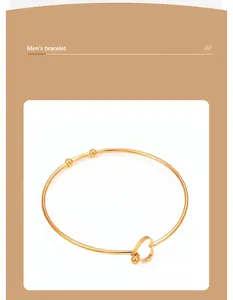 Detailed view of a gold-plated stainless steel heart-shaped open cuff bracelet