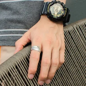 Detailed view of a vintage S925 sterling silver open feather ring worn on a model's hand