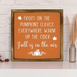 Autumn themed wooden plaque with orange pumpkin quote on a decorative white shelf