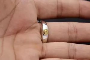 Close-up of S925 sterling silver ring featuring a golden eagle emblem on the band