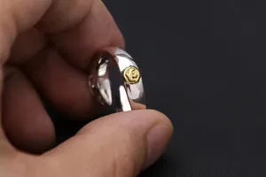 Macro detail of S925 sterling silver ring band featuring a gold-toned eagle medallion inlay