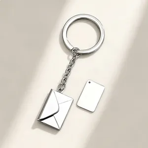 Silver metal envelope keychain pendant with an engravable blank tag for custom DIY gifts.