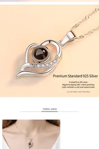 Detail of S925 silver heart necklace with 100 languages projection stone detail.