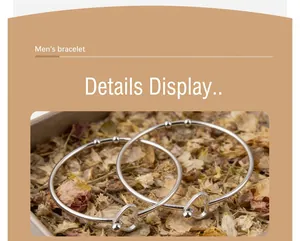 Close-up detail of minimalist stainless steel open bangle with charming heart-shaped ends.