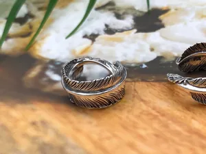 Detailed close-up of a vintage S925 sterling silver feather ring with oxidized finish