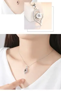 Close-up detail of S925 sterling silver heart pendant with a hidden projection stone