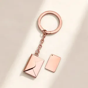 Detailed shot of rose gold envelope keychain with blank plate for personalized DIY engraving