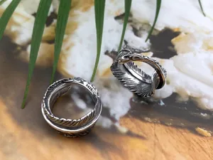 Detailed close-up of S925 sterling silver feather rings with vintage oxidized finish