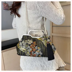 Detailed view of New Chinese style embroidered handbag featuring pearl chain and tassel