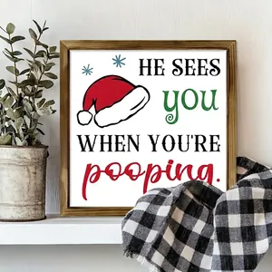 Detail of funny Christmas wood frame sign on a white shelf with plant