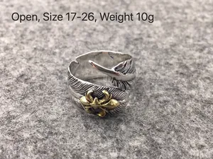 Detailed macro view of vintage S925 sterling silver feather ring with gold accent detail