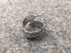Detailed macro view of an S925 Thai silver open feather ring with vintage texture.