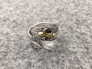 Detail view of an S925 sterling silver Indian style feather open ring with gold eagle