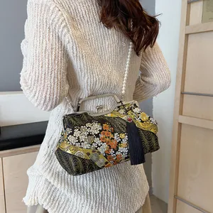 Elegant Chinese style floral embroidered handbag with pearl chain and tassel detail