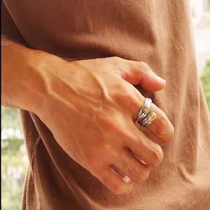 Detailed view of an S925 sterling silver Indian eagle feather open ring worn on a finger