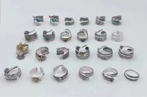 Detailed macro view of various S925 sterling silver feather rings with vintage Thai finish.
