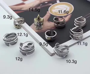 Detailed view of multiple S925 silver Indian feather and eagle rings with specific weights