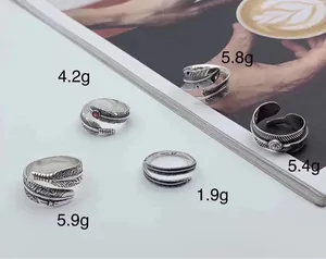 Detailed view of five S925 sterling silver feather rings with individual weight labels