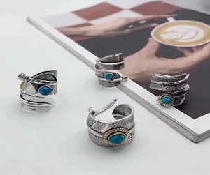 Detail view of S925 silver eagle feather rings with turquoise stones in Thai silver style.