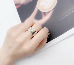 Close-up of vintage S925 Thai silver eagle ring with golden sunburst motif on hand