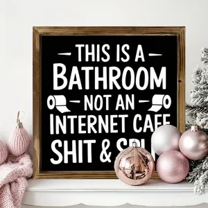 Detailed view of a rustic wooden frame featuring a humorous bathroom sign quote
