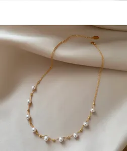 Elegant 18k gold plated necklace with delicate pearls and adjustable chain detail