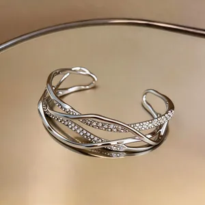 Macro view of multi-layered silver cuff bracelet with pavé cubic zirconia accents
