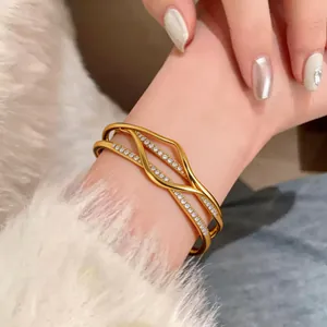 Close-up of 18k gold plated multi-layer bangle with sparkling pave stones detail