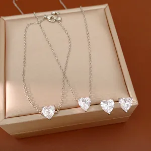 Detailed view of silver heart jewelry set featuring zircon necklaces and stud earrings