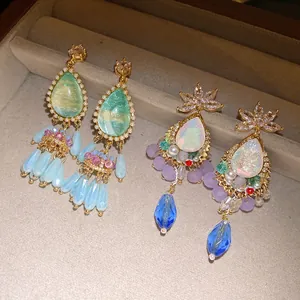 Detailed view of vintage crystal teardrop earrings with colorful tassel fringes