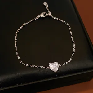 Detailed view of a minimalist heart-shaped cubic zirconia pendant on a silver-toned chain.