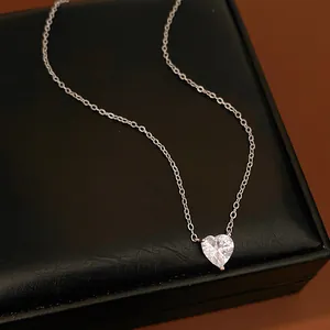 Close-up macro detail of a sparkling silver heart-shaped zirconia pendant necklace
